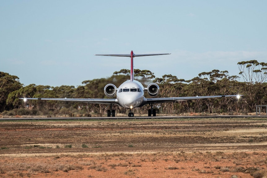 A plane taxis on a runway.  