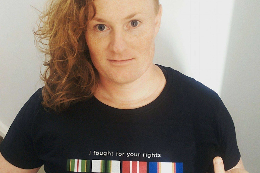 Transgender activist in a protest t-shirt.