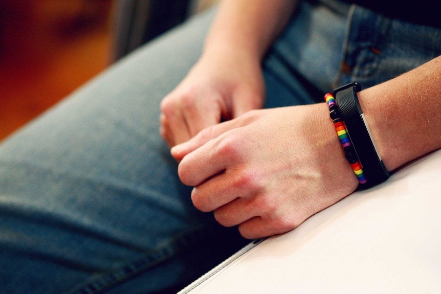 Person wearing rainbow bracelet