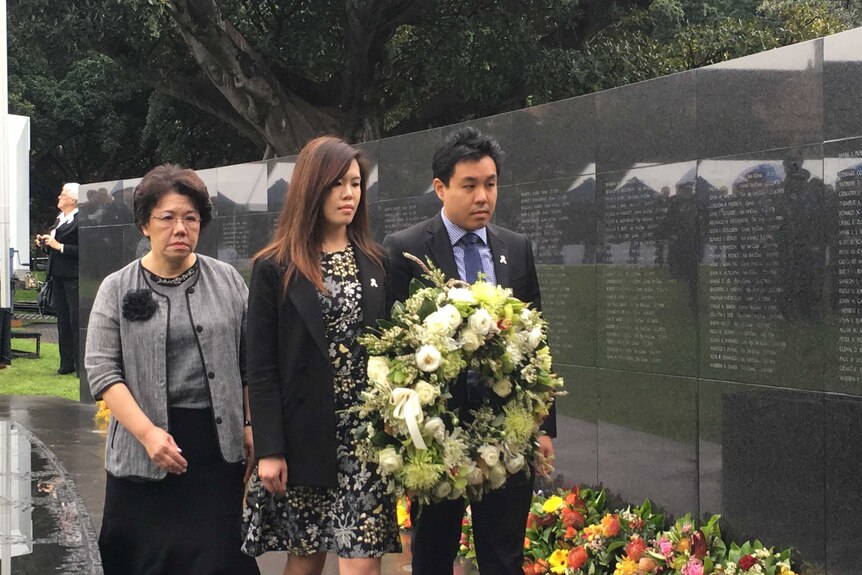 Selina, Zilvia and Alpha Cheng lay a wreath for Curtis Cheng at the NSW Police Memorial.