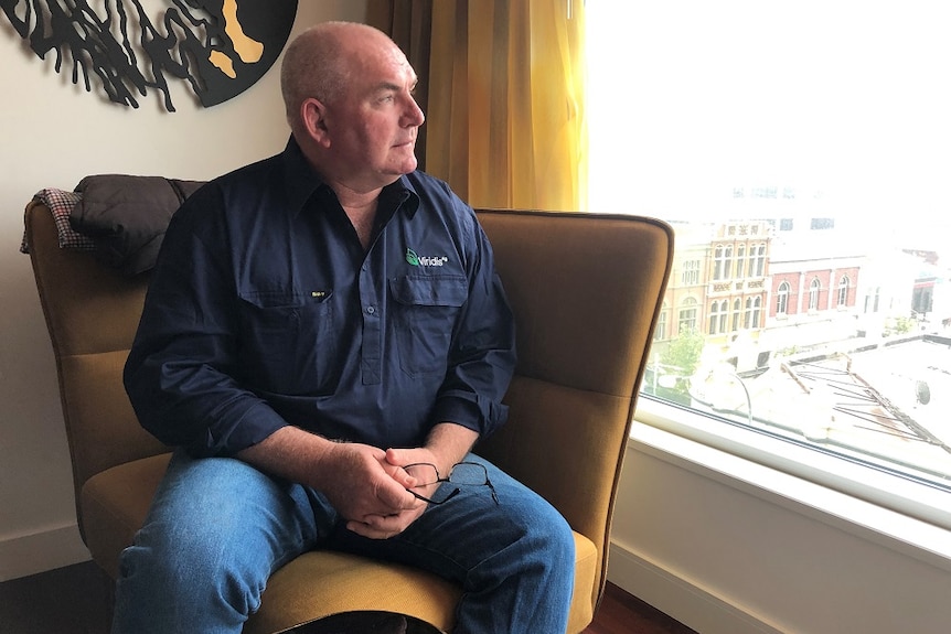 Farm manager Mathew Tonkin in a Perth hotel room looking out over the city.