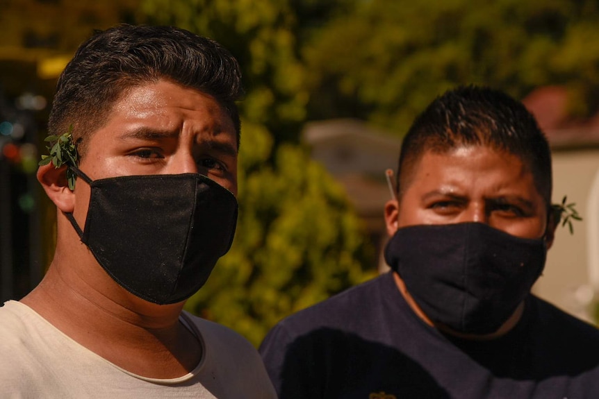 Brothers Armando and Iván at the gravesite of their father in Xochimilco, Mexico City.