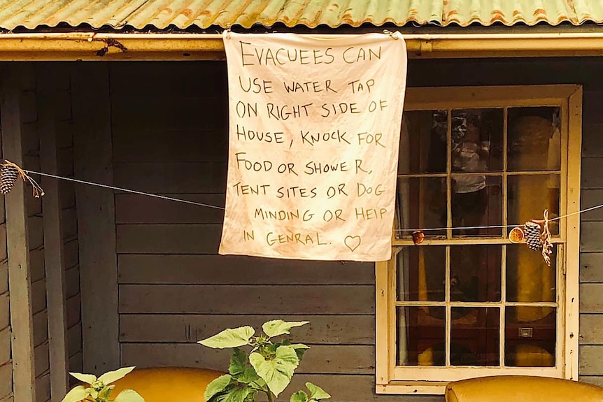 A sign outside a house offering respite for evacuees