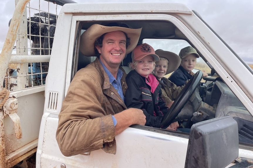 Brook McGlinchey in a ute cab with children Hayley, Wyatt and Sam