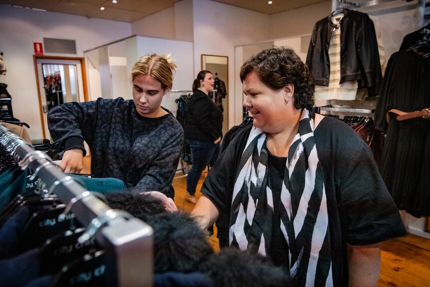 Heidi Arntzen looks through clothes racks with her daughter Emma in a shop in Bendigo..