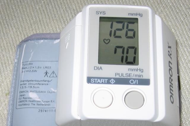 Close up of a blood pressure monitor with the result of 126 over 70