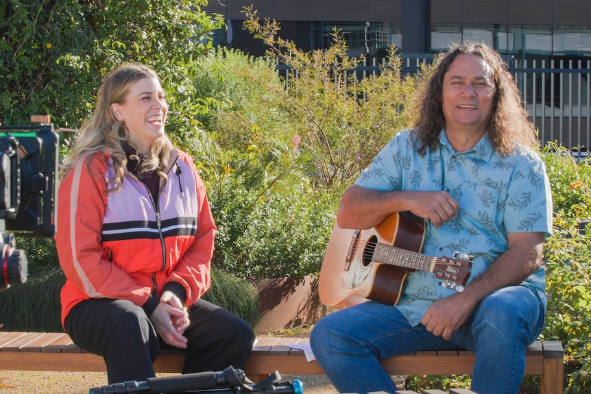 Clarence Slockee and Megan Burslem laughing while at South Eveleigh Rooftop Garden in South Eveleigh.