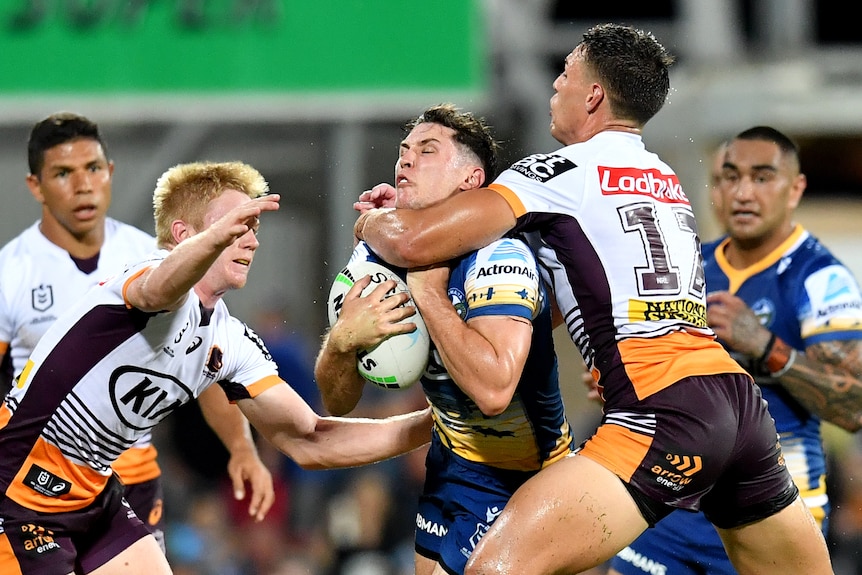 Mitchell Moses is tackled with an arm around his throat
