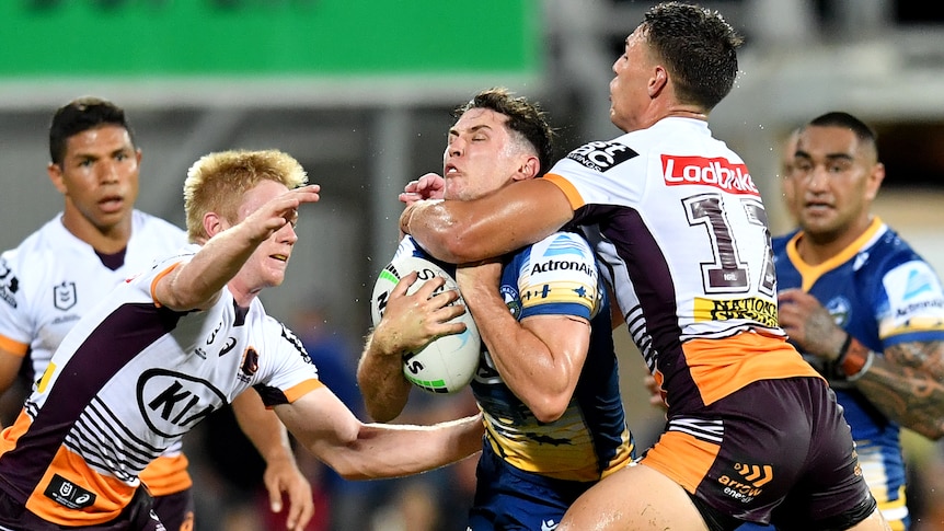 Mitchell Moses is tackled with an arm around his throat