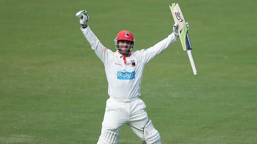 The Redbacks' Phil Hughes celebrates after reaching a double century against Western Australia.
