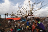 People bathe using water from a broken water pipe