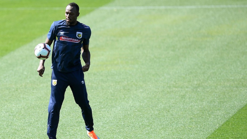 Usain bolt about to chest a ball at a Central Coast Mariners training session.