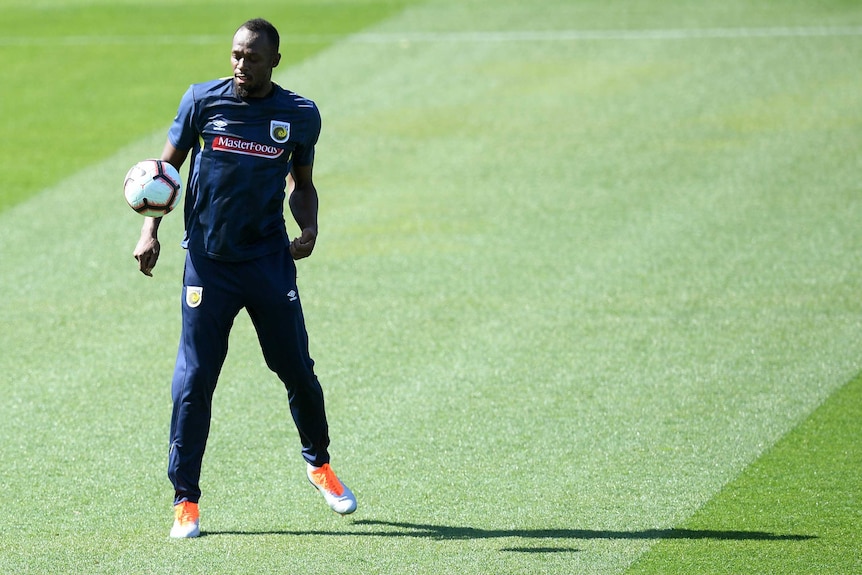 Usain bolt about to chest a ball at a Central Coast Mariners training session.