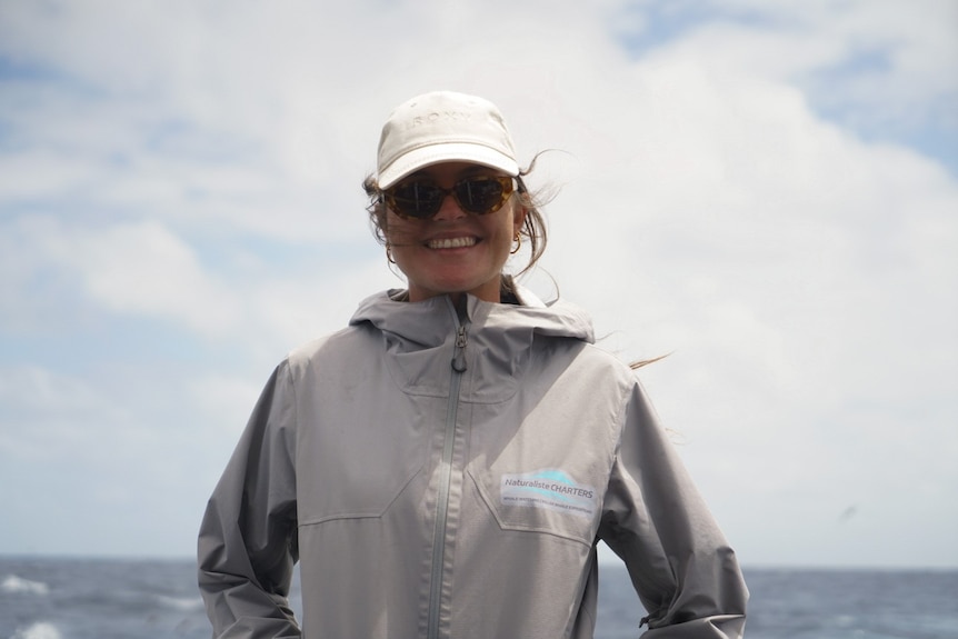 A woman in a jacket with sunglasses on