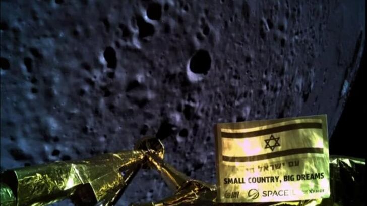 A gold Moon lander is seen on the bottom of the screen with the Moon in darkness taking up the majority of the image.