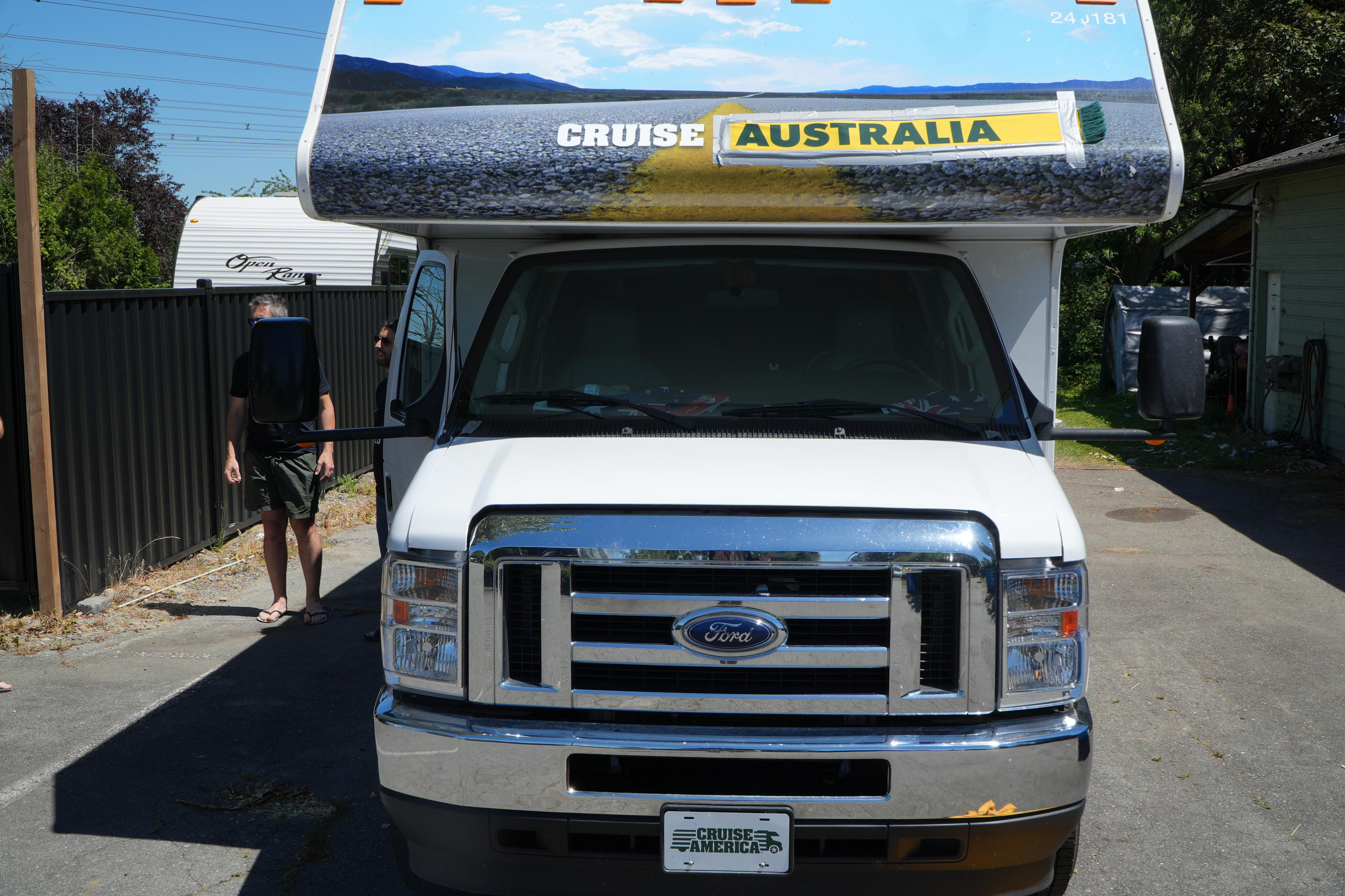 An RV which says 'Cruise Australia' with the Australia a taped on scarf