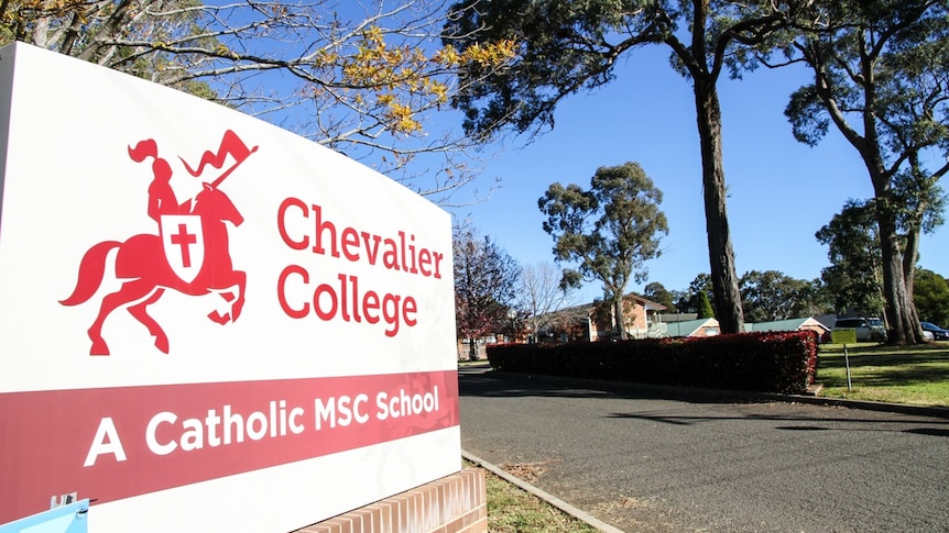 A sign with a stylised horseman that reads "Chevalier College".