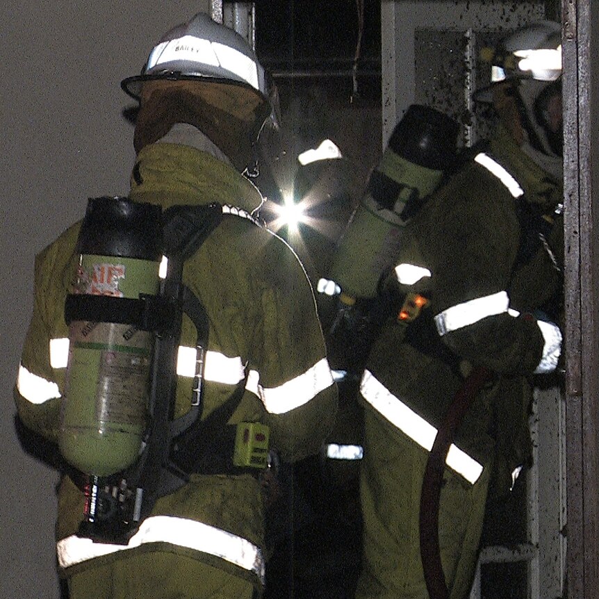 Firefighters enter house at night