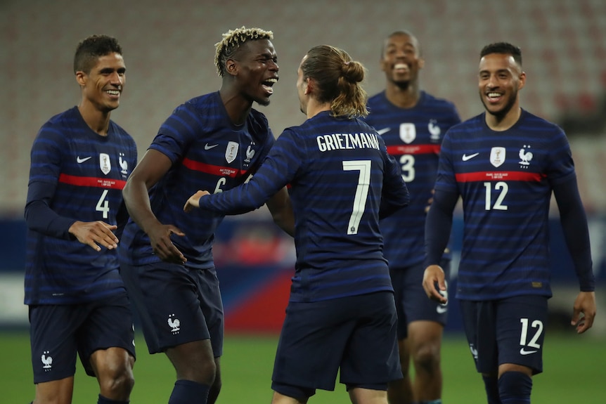 France players Paul Pogba and Antoine Griezmann celebrate by hugging
