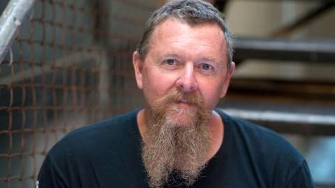 Headshot of Bradley Upton, with a beard.