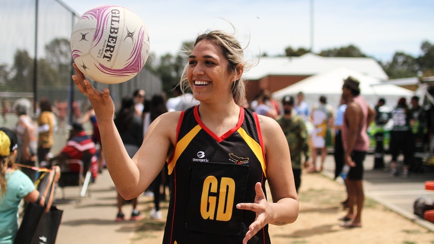 Netball player Clarinda Hudson from the  Black Eagles from Shepparton spins a ball on her finger.