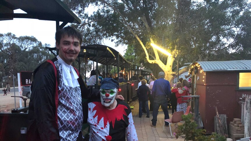 Steve and Jake Kellow in Halloween costume next to an old diesel train at Cobdogla.