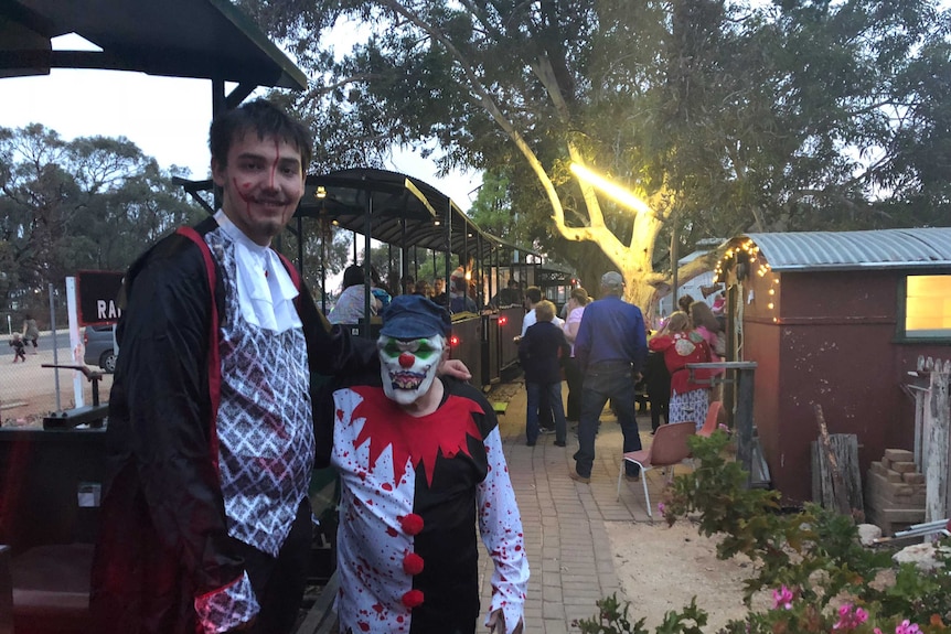 Steve and Jake Kellow in Halloween costume next to an old diesel train at Cobdogla.