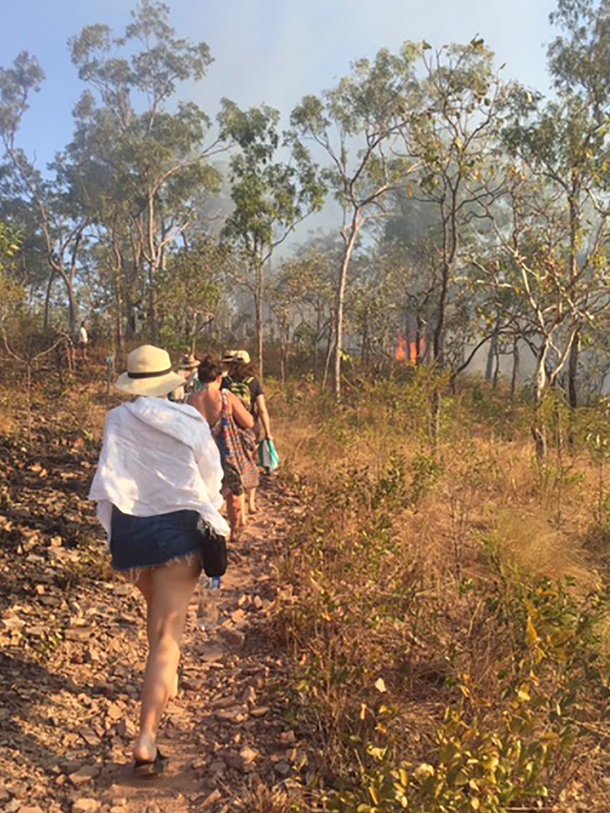 A group of tourists leaving the Litchfield National Park swimming spot.