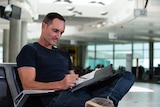 Robert Brownhall sketching from the waiting area in Brisbane's domestic airport.