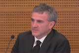 Terrence McMaster pictured behind a microphone in the witness stand at the banking royal commission.
