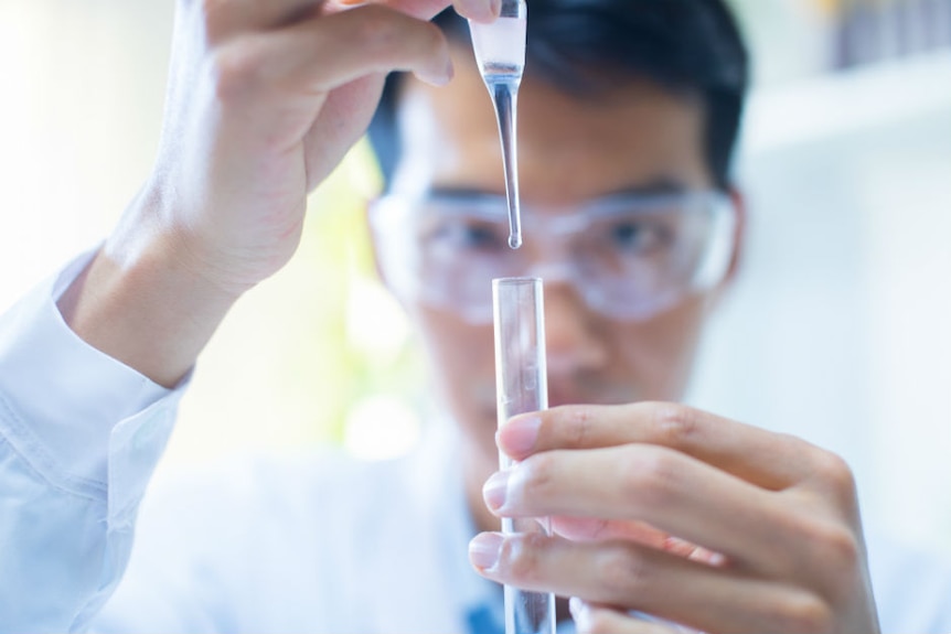 A scientist holding a test tube.