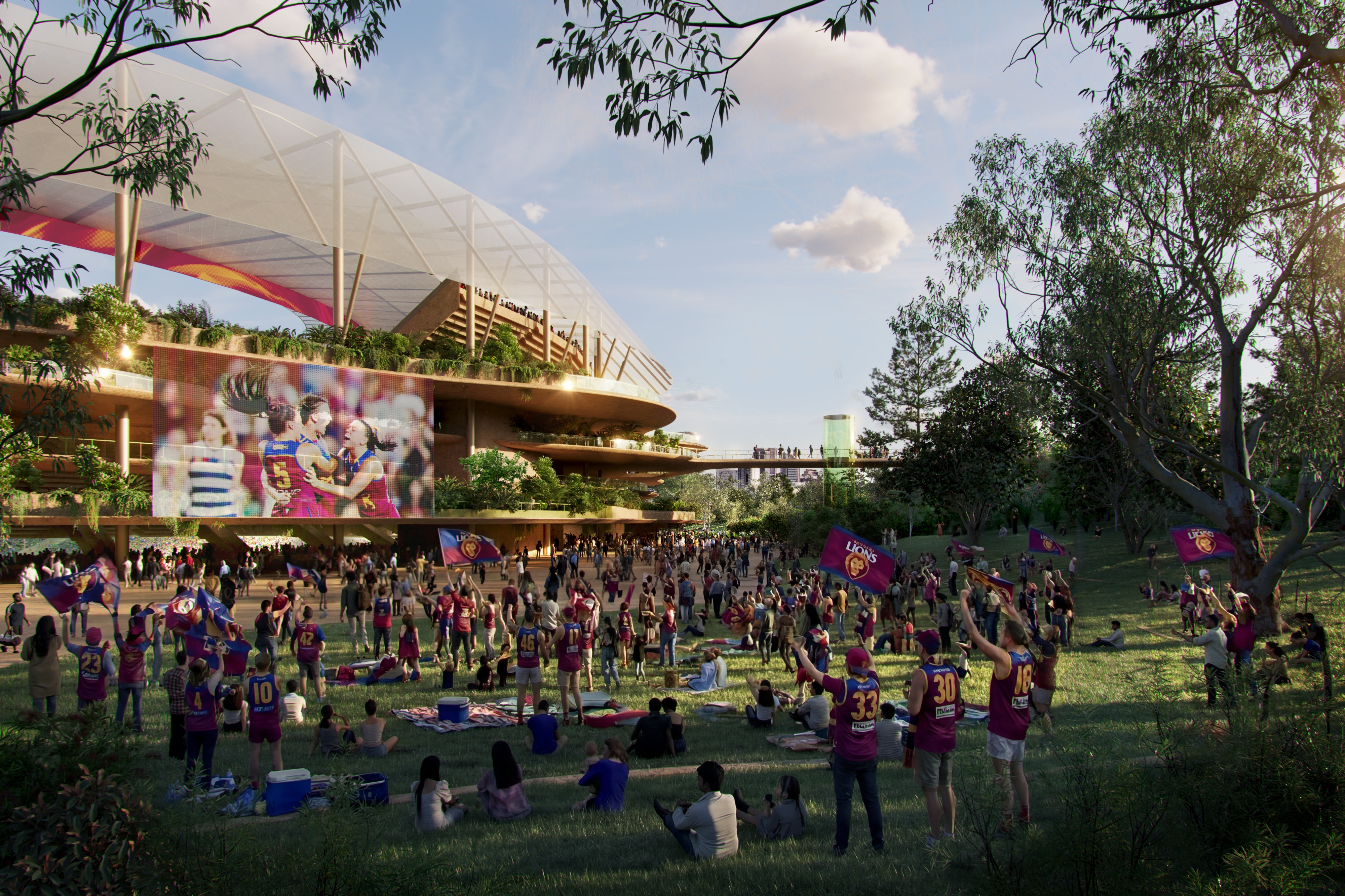 People outside a stadium watching a Lions AFL game. 