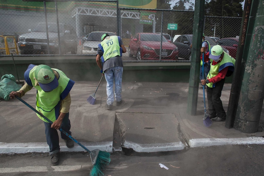 Workers sweep ash from the Volcan del Fuego. Several surrounding areas were blanketed in ash following the eruption.