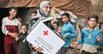 Masira and her children receive a hygiene kit from the Red Cross in Beruit.