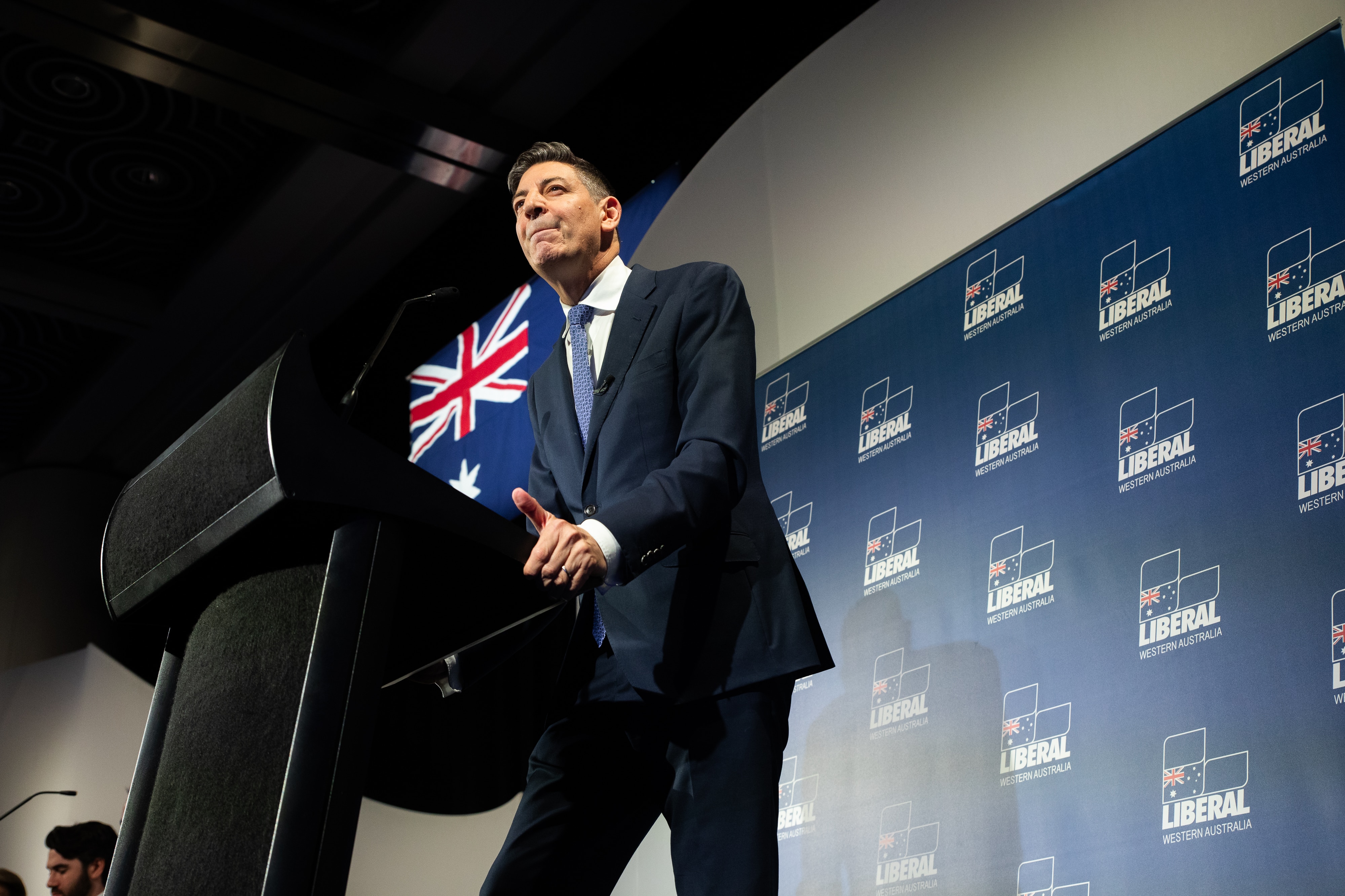 Basil Zempilas grips onto a lectern while speaking.