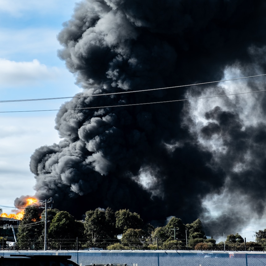 Black plumes of smoke rise from a factory fire in suburban Melbourne.