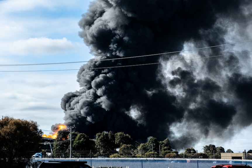 Black plumes of smoke rise from a factory fire in suburban Melbourne.