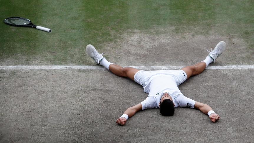 Novak Djokovic lies on court