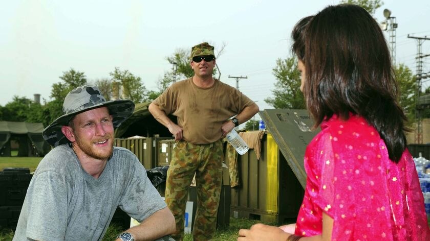 RAN Medical Officer Joel Hissink chats with a local Pakistani girl at Camp Cockatoo