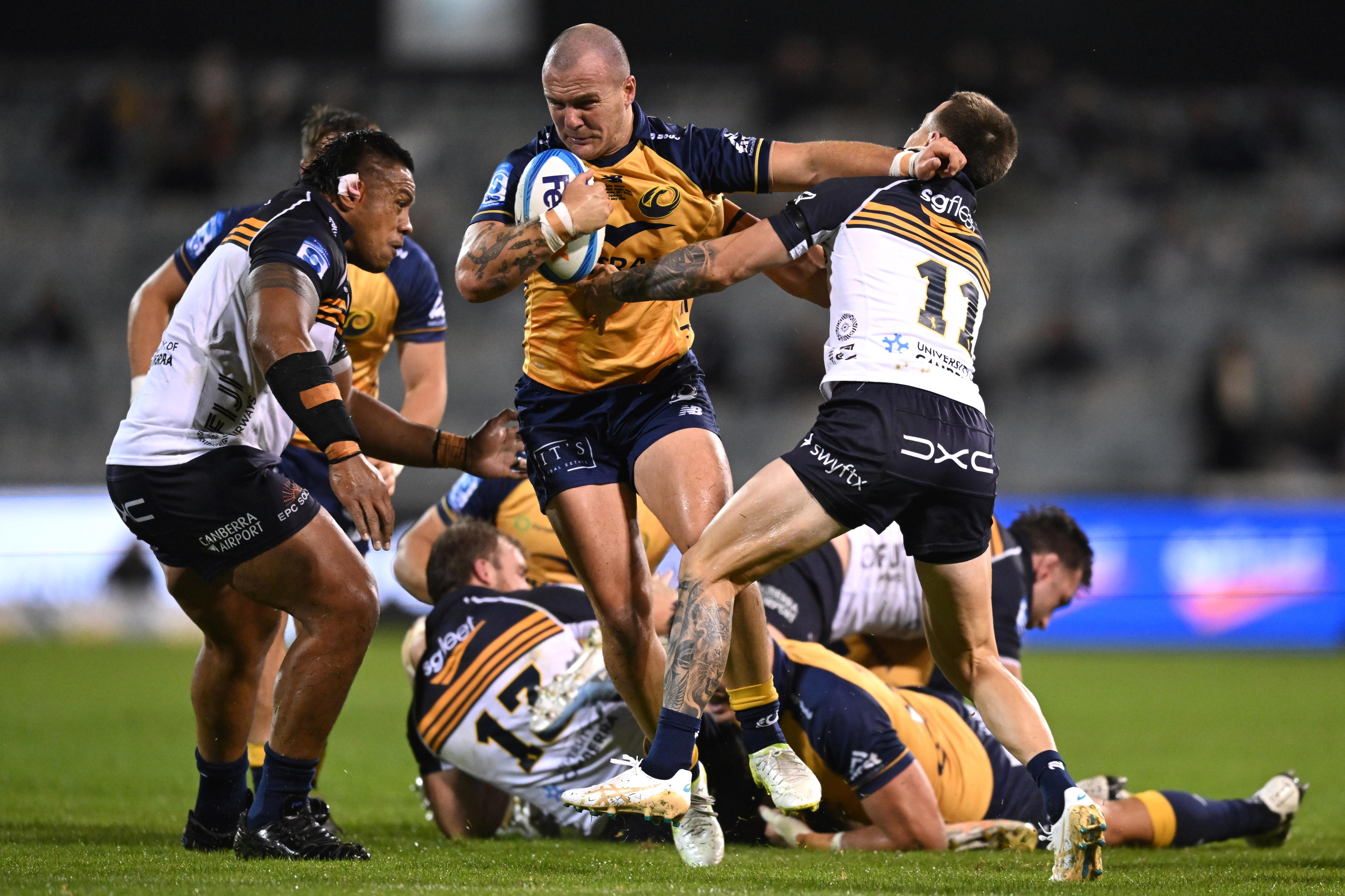 Dylan Pietsch runs with the ball as he meets the Brumbies defence during a 2026 match.