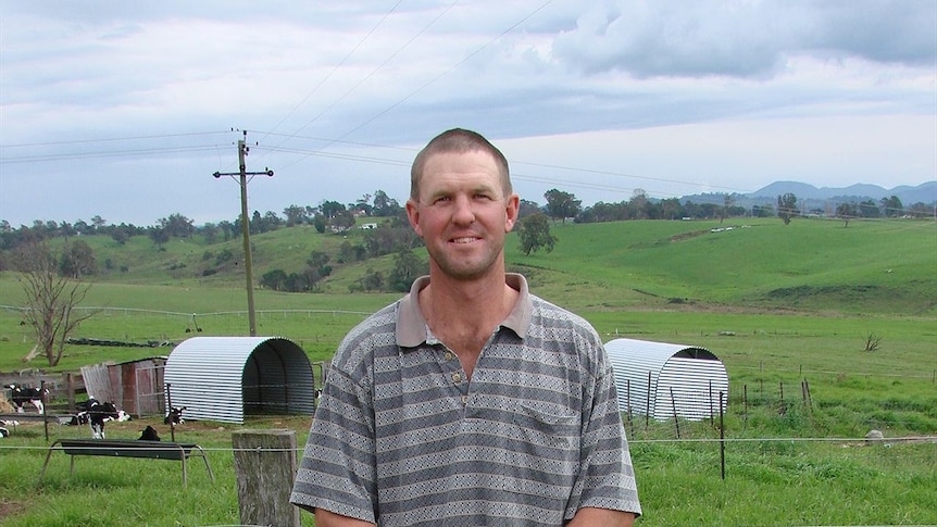 Craig Bassett with dairy calf sheds he made