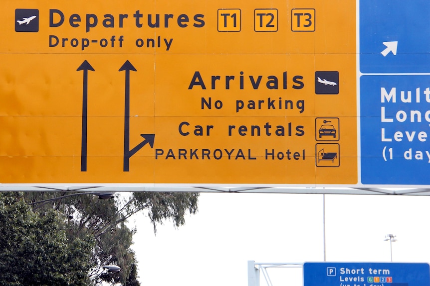 Departure/arrival signs at the entrance to Melbourne Airport.