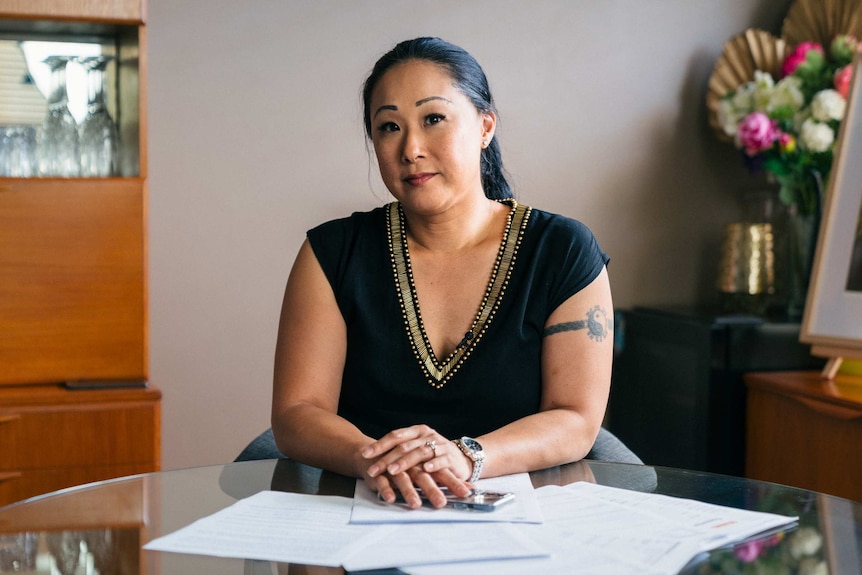 Phoebe Pun looks into the camera, while sitting at a table.