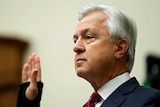 Wells Fargo chief executive John Stumpf raises his right hand while being sworn in at House Financial Services Committee
