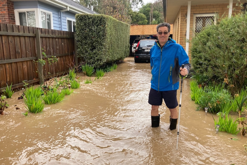 Alan Scarlett standing in flooded driveway