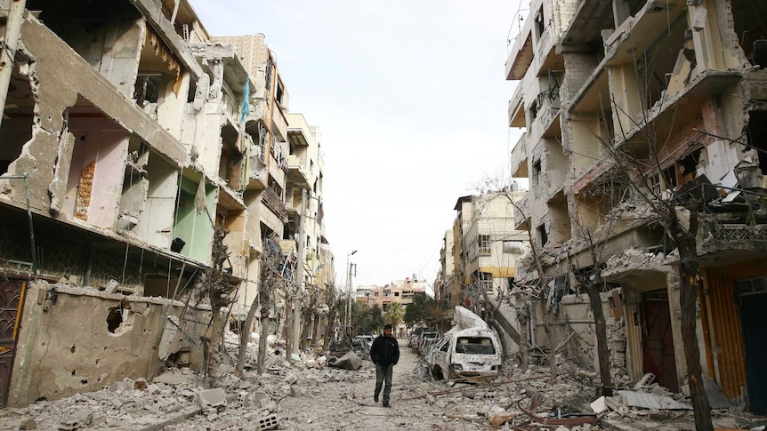 A man walks on a damaged street in the besieged town of Douma, eastern Ghouta.