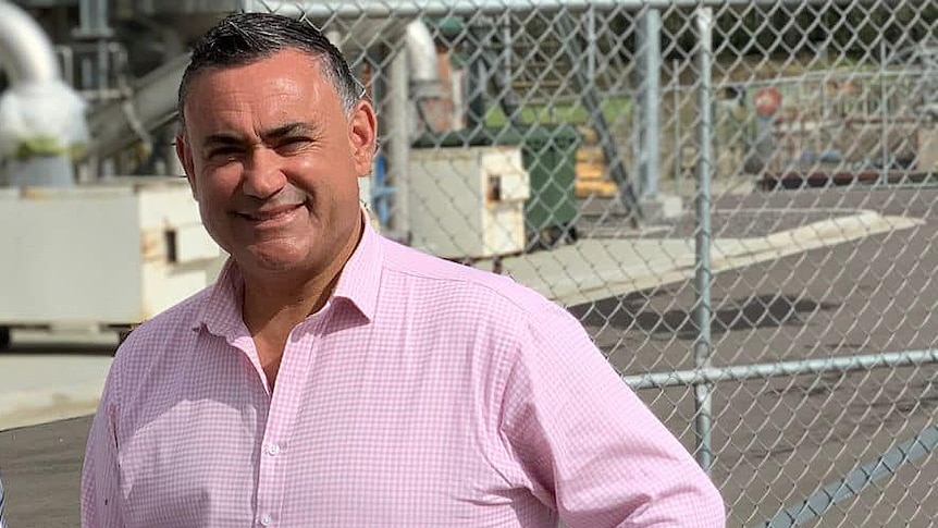 a man standing in front of a steel gate