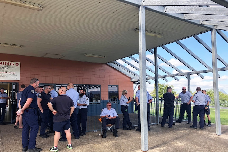 Prison guards gather outside building at Woodford Correctional Centre, north of Brisbane