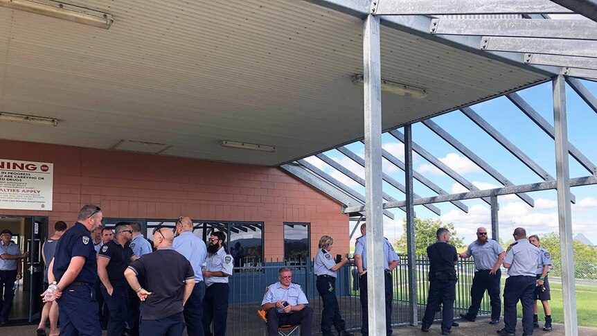 Prison guards gather outside building at Woodford Correctional Centre, north of Brisbane