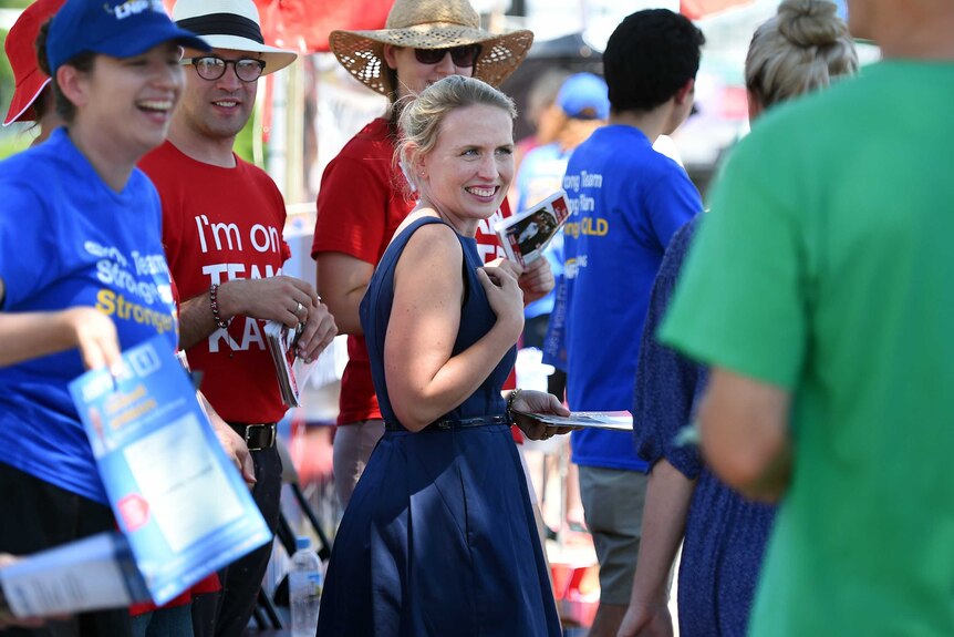 Kate Jones greets voters outside a polling booth in Brisbane